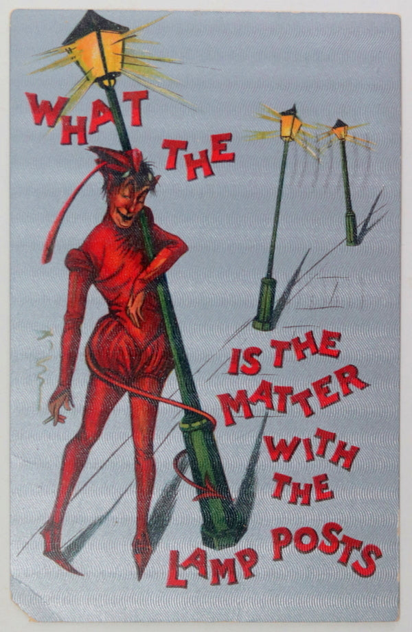 1910 USA postcard inebriated devil held up by lamp posts