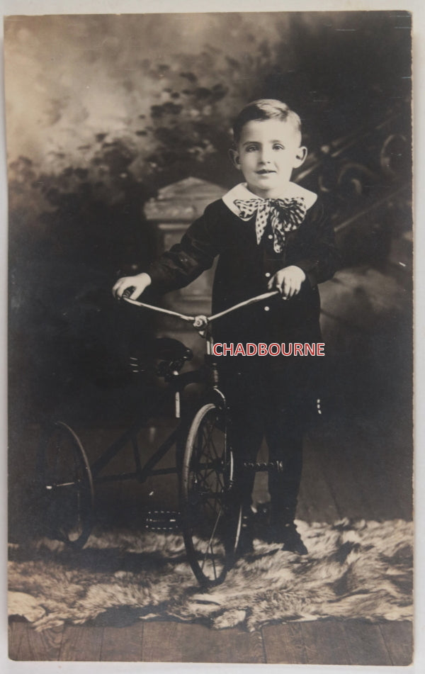 USA RPPC photo postcard of 4-year old James with his tricycle