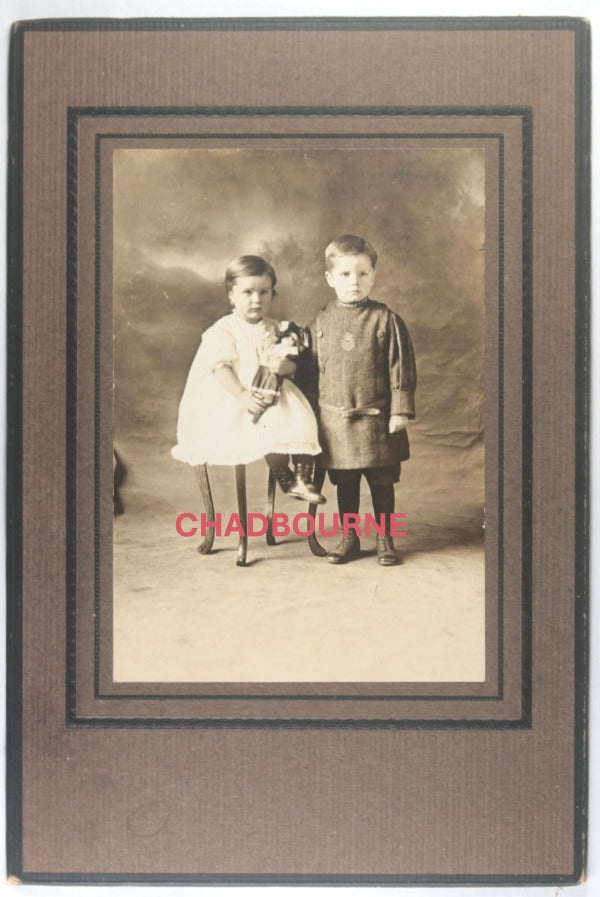 Canada studio photo, brother has military tunic, sister with doll