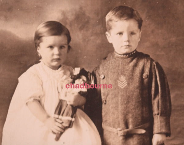 Canada studio photo, brother has military tunic, sister with doll