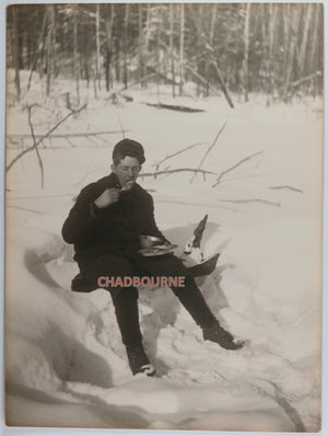 1909 Canada R.R. Sallows photo man on snowbank eating