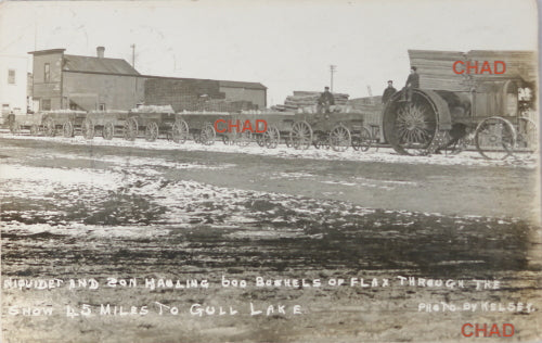 1913 RPPC photo postcard tractor hauling wagons of flax N.S. Canada