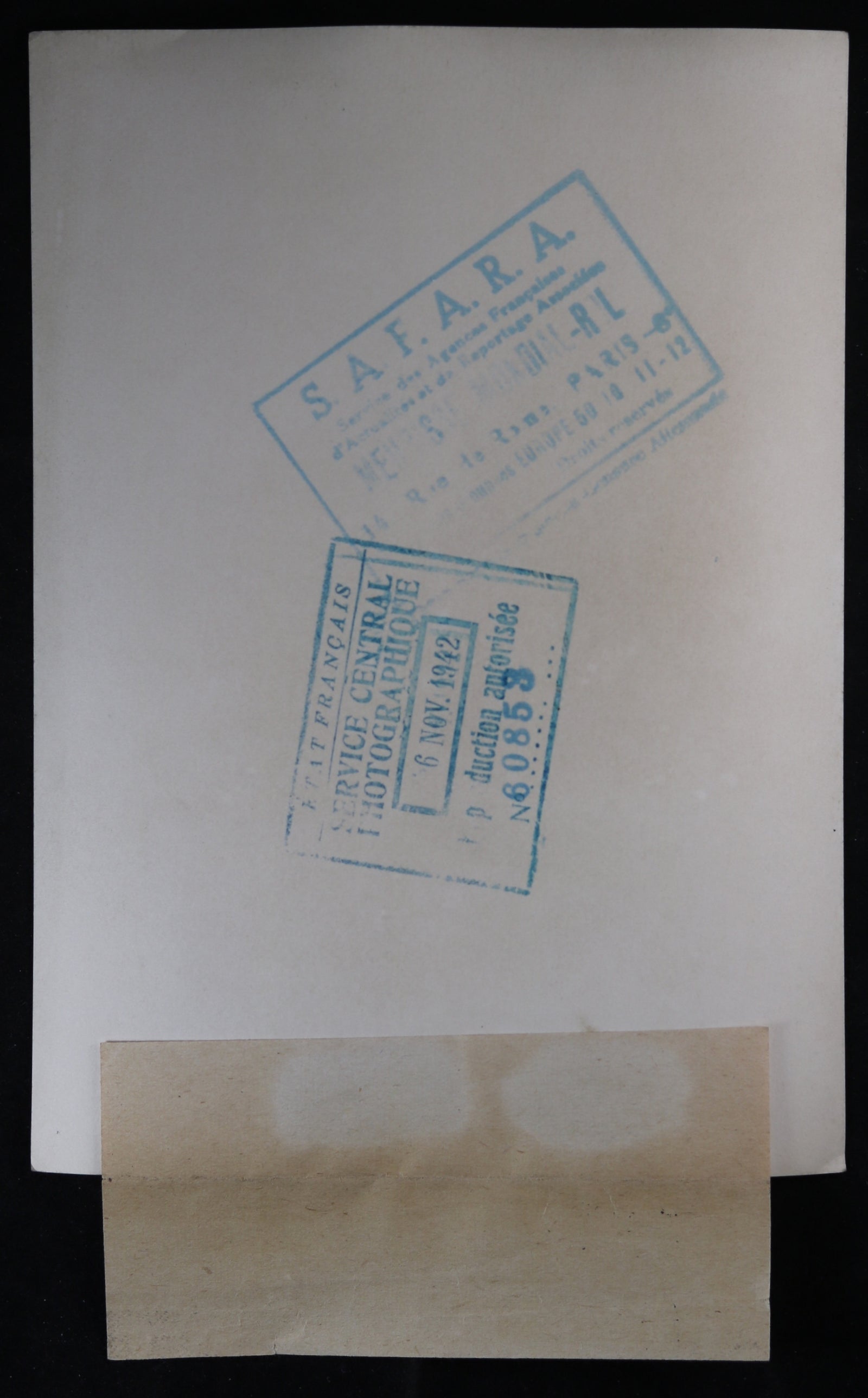 1942 photo of German submarine watching British cargo ship sinking