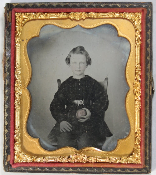 Ambrotype photo of child in chair holding apple c. 1860s