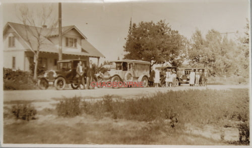 Early 1900s photo of hearse in front of house, with family and friends