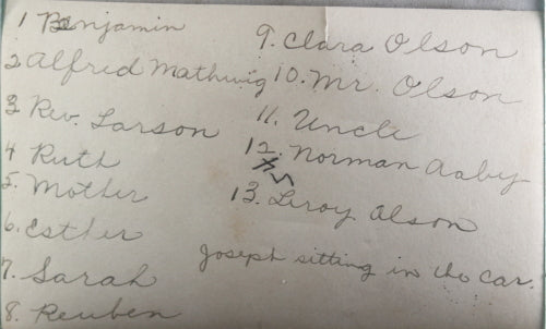 Early 1900s photo of hearse in front of house, with family and friends