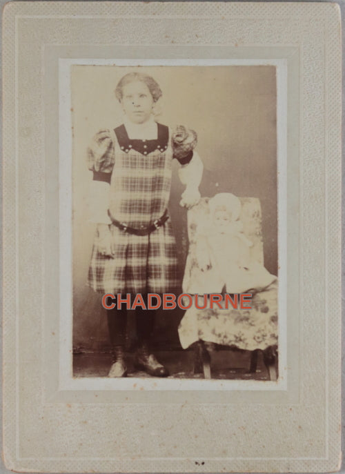 Early photo of identified young girl with doll