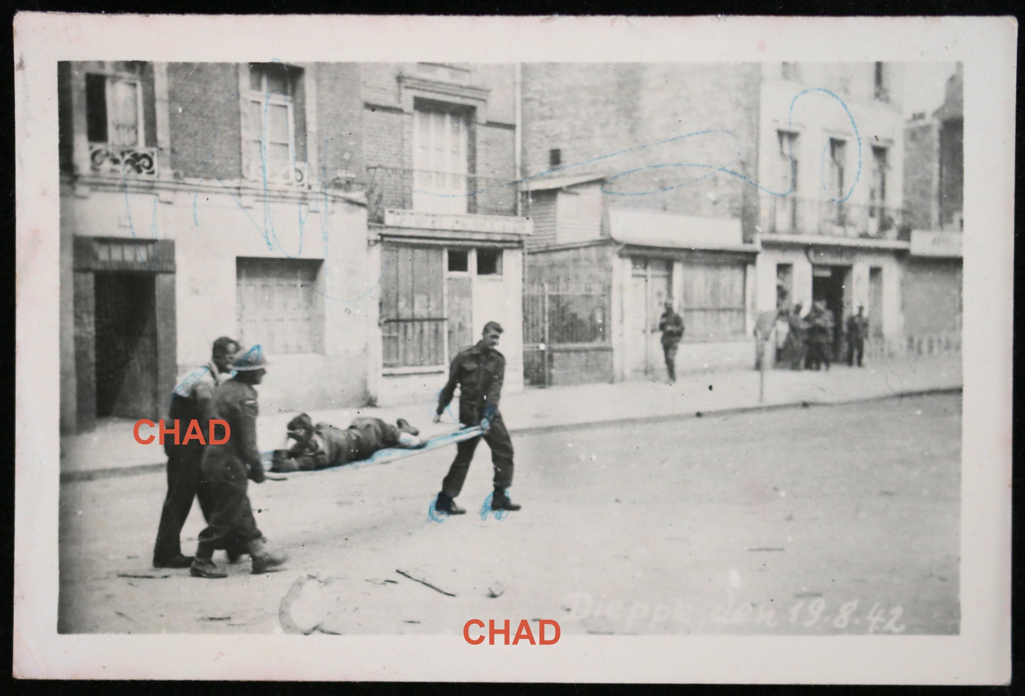 1942 WW2 photo of Canadian POWs carrying wounded friend at Dieppe