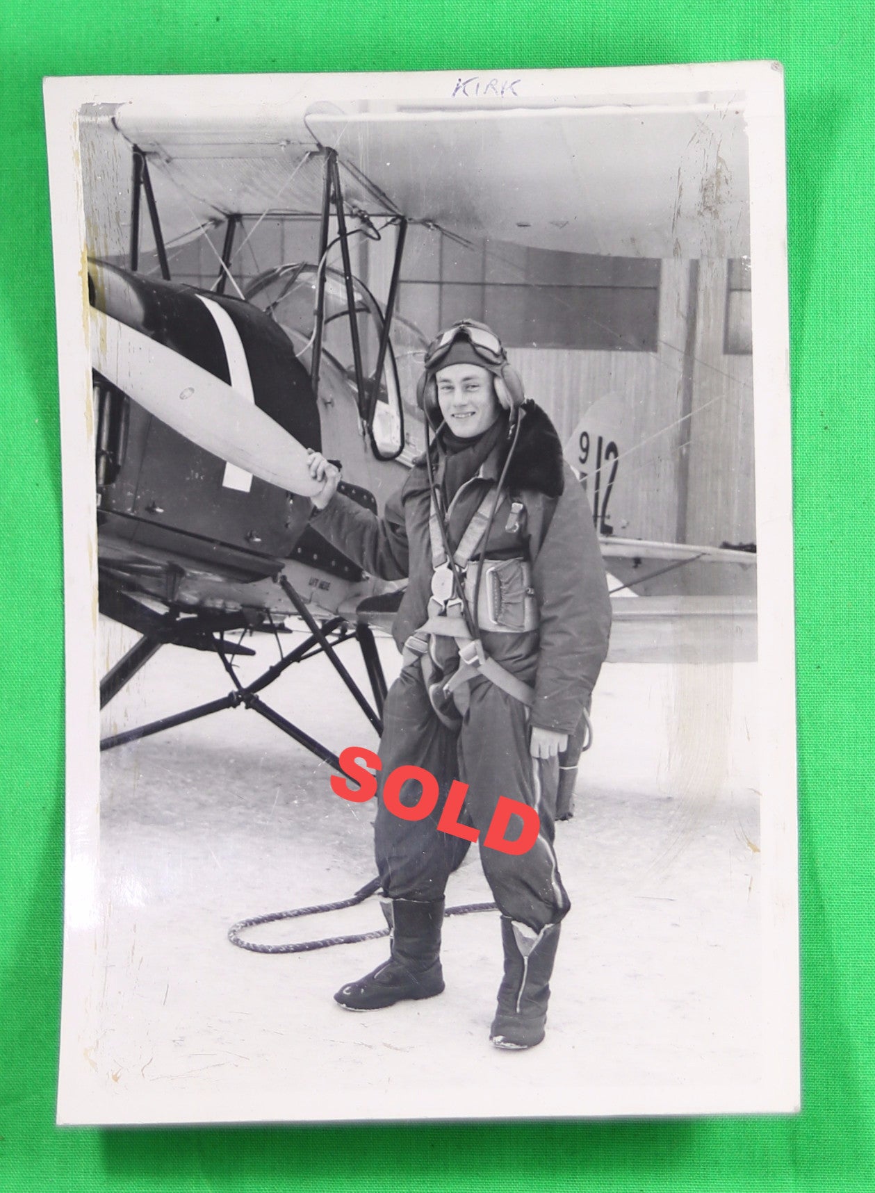 Photo of pilot beside biplane with winter skis - Canada WW2