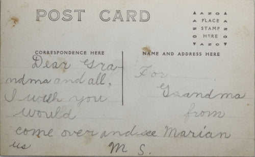 Photo postcard of young girl holding her baby sibling Canada c. 1920s