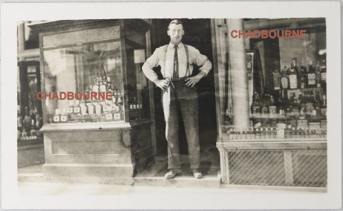 UK photo postcard of owner standing in front of liquor store c. 1910s UK photo postcard of owner standing in front of liquor store c. 1910s