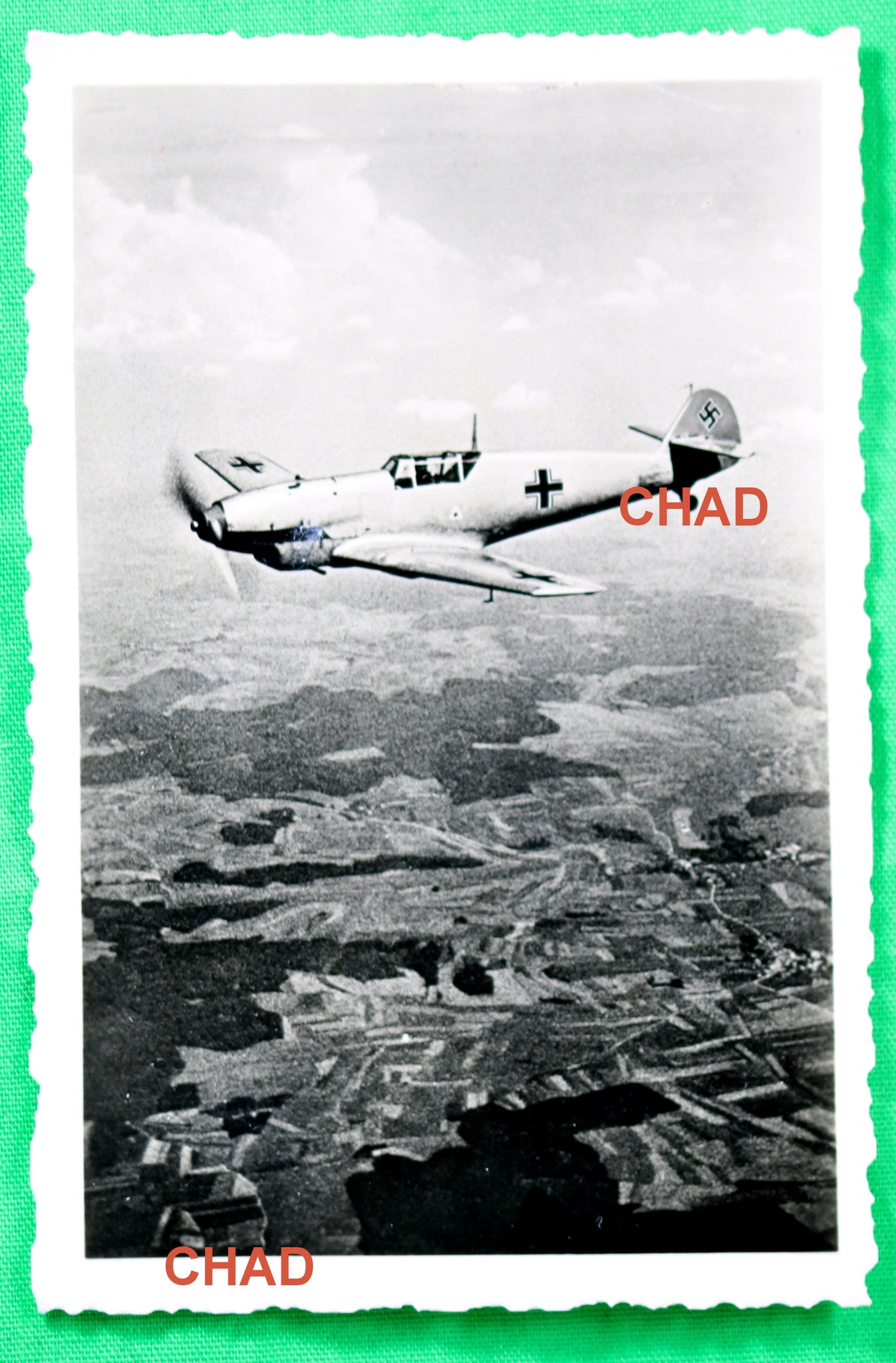 WW2 Propaganda photo of German Messerschmitt Me 109 in flight over countryside