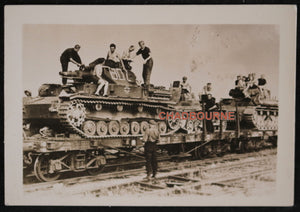 WW2 photo of three German Panzer tanks on train, going back to Germany
